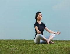 Chinese Woman in black t-shirt Performing yoga.